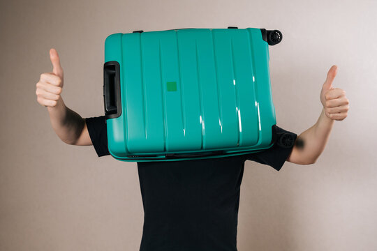 Traveler is happily preparing for an international adventure, using a vibrant travel bag to represent their head, conveying humor and a positive attitude towards holidays and exploration.