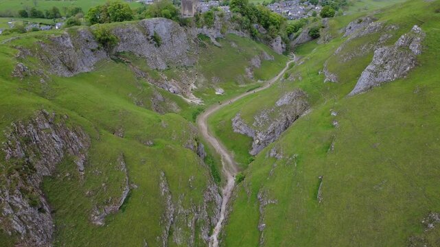 Aerial view of the dramatic Cave Dale limestone valley with a hiking path, Castleton, Peak District, England