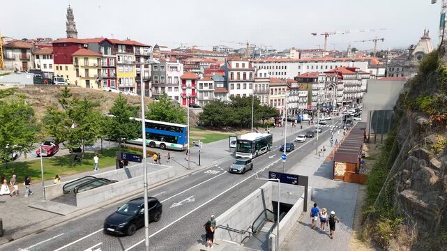 Porto, Portugal - 28 July 2026: Aerial view of Av. Dom Afonso Henriques with historic buildings, a double-decker bus, and metro station entrances.