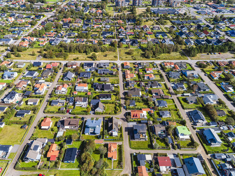 Aerial view of Skrea strand residential area with detached houses, green lawns, and tree-lined streets in Falkenberg, Halland County, Sweden.