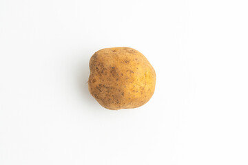 Fototapeta premium Single fresh raw brown baby potato isolated on a white background