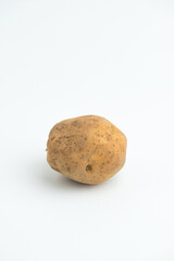 Fototapeta premium Single fresh raw brown baby potato isolated on a white background