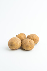 Fototapeta premium Small pile of fresh raw brown baby potatoes isolated on white background