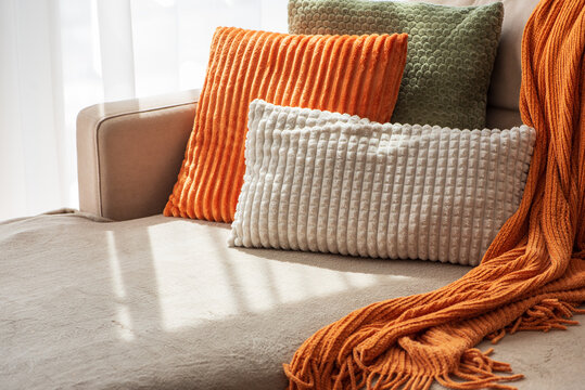 Cozy Sofa Arrangement With Plush Cushions And Knitted Throw For Home Decor Comfort