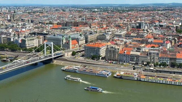 High view of the Danube River and the Pest section of Budapest, Hungary from Szabadsag-szobar Citadel (Fort) on a summer day with riverboats sailing.