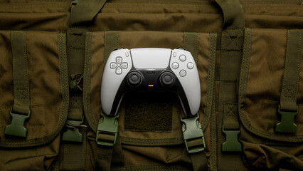 Modern white gamepad on tactical bag © solidmaks