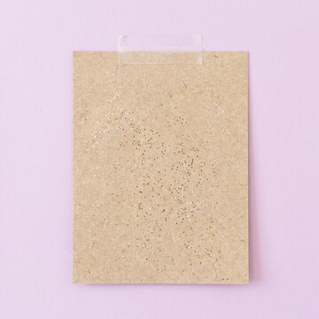Blank textured beige note card on soft purple background with textured, template
