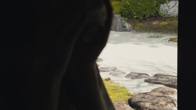 Woman admiring a japanese dry landscape garden