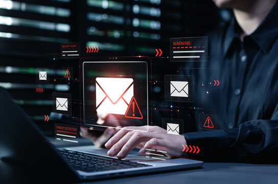 Cybersecurity phishing alert on laptop shows malicious email warning interface as user works online, illustrating threat detection, data protection, network security, fraud prevention, risk management