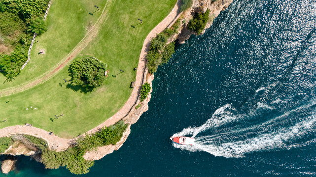 Speedboat leaving a curved wake beside Duden Park in Antalya