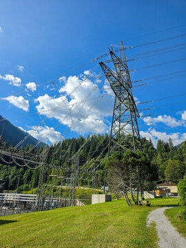 high voltage power lines and electricity pylon in a scenic alpine mountain landscape