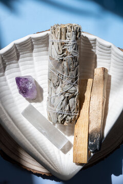 white sage, palo santo, and crystals on ceramic plate for spiritual cleansing and meditation
