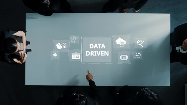 A corporate meeting showcasing a data driven approach with visuals representing analytics and cloud technology on the table, highlighting teamwork and finance strategies. Raster