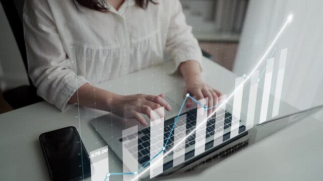 A business professional engages with financial data on a laptop, featuring a digital graph overlay that illustrates growth and performance metrics in a modern office setting. Copula