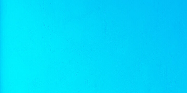 Vibrant cyan blue solid painted wall texture background