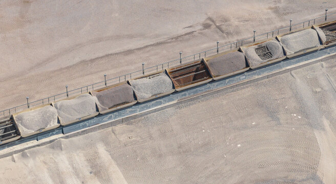 Aerial view of an industrial screening system separating crushed stone into different aggregate sizes at a quarry processing facility in Valence, Auvergne-Rhone-Alpes, France.