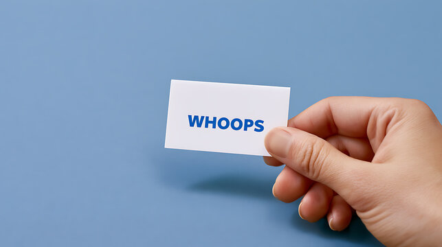 A hand holds a white card with the word 'WHOOPS' in blue letters, signifying a mistake, error, or an accidental situation with light blue background