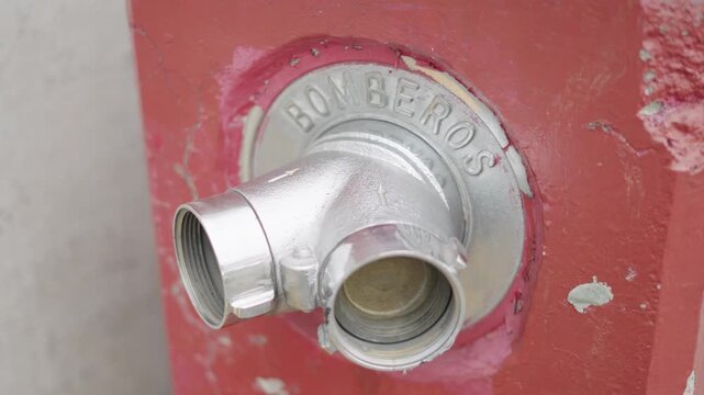 Close up of a red fire hydrant with the spanish word for firefighters, bomberos, in mexico city