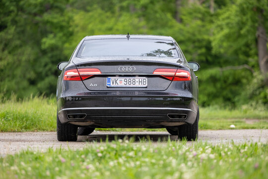 Rear View Of Black Audi A8 Luxury Sedan Parked On Wet Road With Croatian License Plate