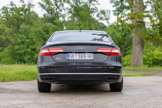 Rear View Of Black Audi A8 Luxury Sedan Parked On Wet Road With Croatian License Plate