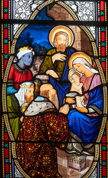 Stained glass (19th century) of Christmas Nativity Scene : Adoration of the Magi as they present gifts of gold, frankincense and myrrh to the Infant Jesus.