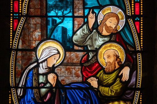 Stained glass (19th century) of Death of Saint Joseph surrounded by Mary and Jesus.