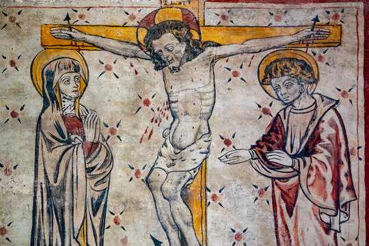 Fresco (12th century) of Jesus Christ crucified on the cross represented with Mary and Saint John.