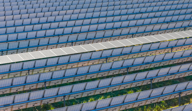 Aerial view of photovoltaic panels with a single-axis solar tracking system at a large solar power plant in Le Pouzin, Auvergne-Rhone-Alpes, France.