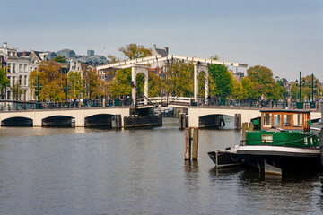 Fototapeta premium Traditional historic wooden drawbridge Magere Brug over Amstel river in Amsterdam Netherlands