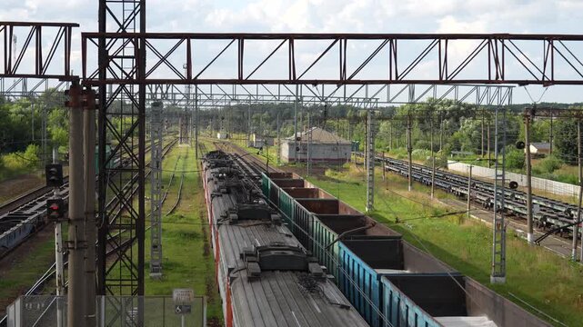 Freight Trains and Electric Locomotives at Large Railway Yard in Russia
