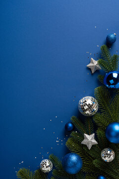 Blue Christmas ornaments with vertical evergreen branch and silver stars for Merry Christmas and Happy New Year