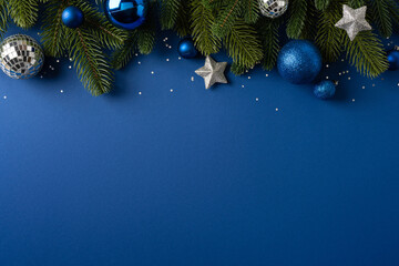 Naklejka premium Blue Christmas ornaments and fir branches on blue background for Merry Christmas and Happy New Year