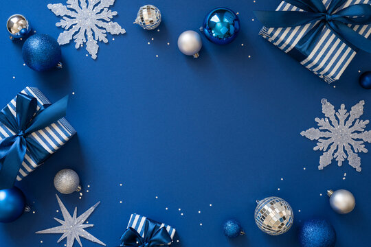 Blue Christmas gift and ornament arrangement with snowflakes ribbons and festive baubles for holiday season