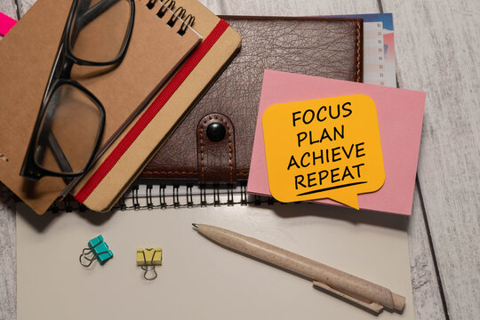 Focus Plan Achieve Repeat - Productivity and Goal Setting Concept on Office Workspace.
