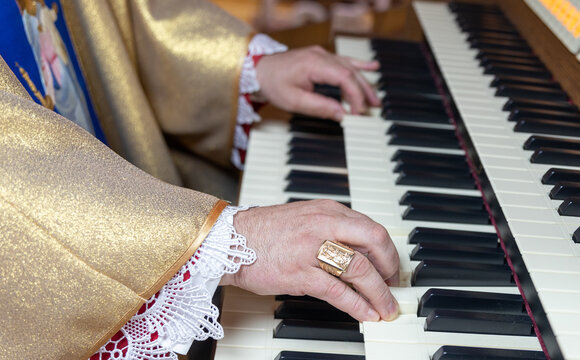 Organist Playing Pipe Organ Keyboard During Musical Performance.