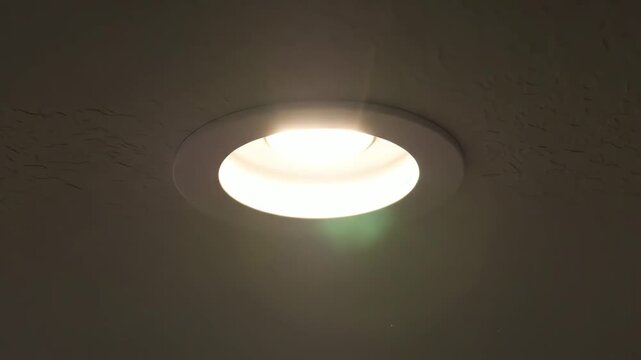 Close up of recessed ceiling light fixture in dark room