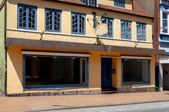 Vacant Retail Storefront in Historic Building with Empty Shop Windows