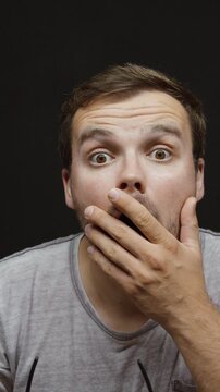 Man removes his glasses and reacts with extreme surprise, showing shock, disbelief and an amazed facial expression.