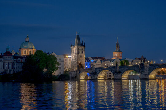 Prague at Night with Charles Bridge and Old Town Bridge Tower over the Vltava River