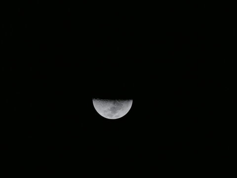 Half Moon Glowing in the Dark Night Sky in Paraguay