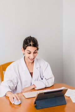 Female doctor providing online consultation using digital tablet