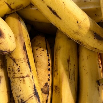 Close up of ripe yellow bananas with brown spots pattern