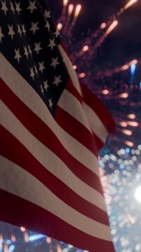 American flag waving in the night sky amidst exploding fireworks