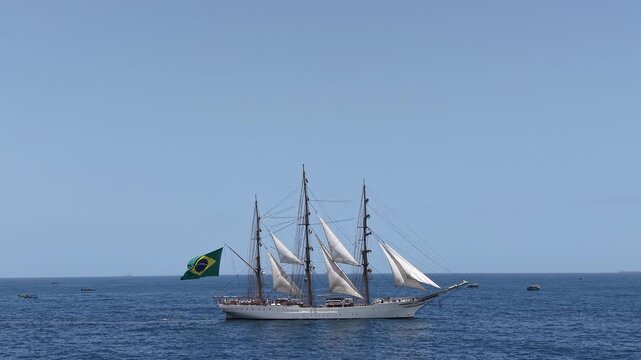 Aerial view of a three-masted sailing ship with sails sailing in the Atlantic Ocean. 