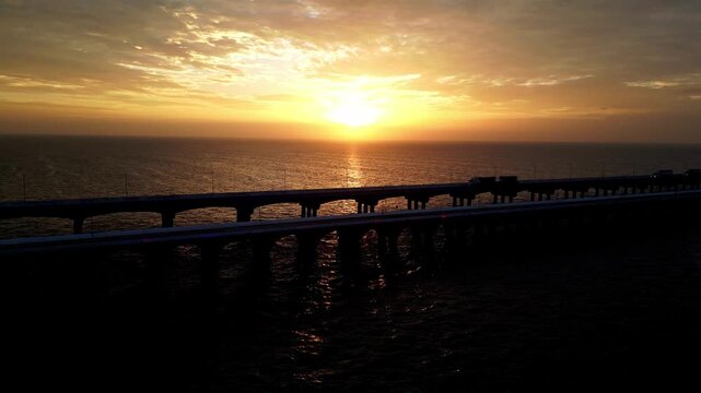 Aerial view of the Progreso pier at sunset with traffic crossing