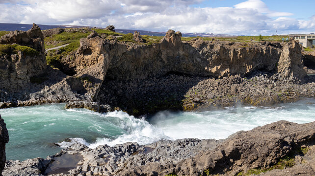 Volcanic Rock Cliffs and Rushing Turquoise River Near Godafoss in Iceland