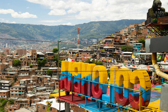 Medell&iacute;n, Antioquia, Colombia - June 29, 2026 - Panoramic view of the city from Comuna 13, featuring colorful letters spelling Colombia that stand out against the urban landscape