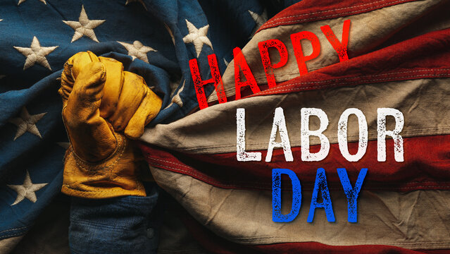 Happy Labor Day greeting text with worn yellow work glove holding the US American flag. Symbolic of blue collar workers, USA manufacturing, pride in products Made in United States of America.