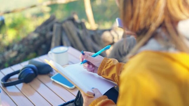 Asian man and woman remote working corporate business on digital tablet and smartphone while travel nature camping in forest with drinking coffee. Digital nomad workation outdoor active lifestyle
