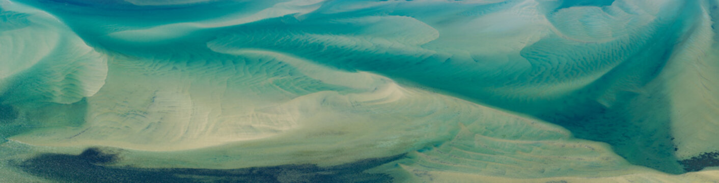Currents from the North Atlantic Ocean continuously shape the sand banks and beaches of Cape Cod, Massachusetts. The entire peninsula is in constant movement due to its geologic makeup of mostly sand.